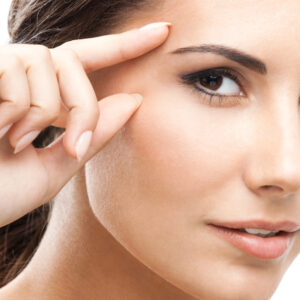 Woman touching skin or applying cream, isolated